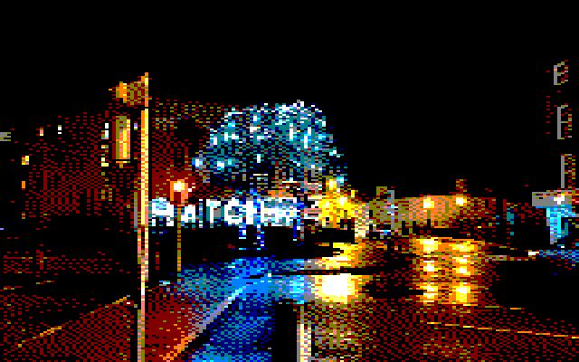 Image converted by 'CPiC'. Night view of Carlow street with a large tree decorated with blue lights in the center. Traffic lights on the left and a building on the right.