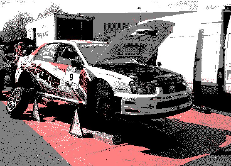 Image converted by 'CPiC'. The white Subaru Impreza, rally car, with red and yellow accents and the number 9, on a red platform with its hood open. Other cars and equipment in the background.
