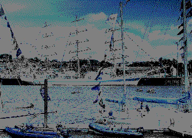 Image converted by 'CPiC'. The harbor with several boats and ships moored, in the center a large white yacht with three masts. A Ferris wheel is visible in the background, and smaller boats with colorful flags to the right.