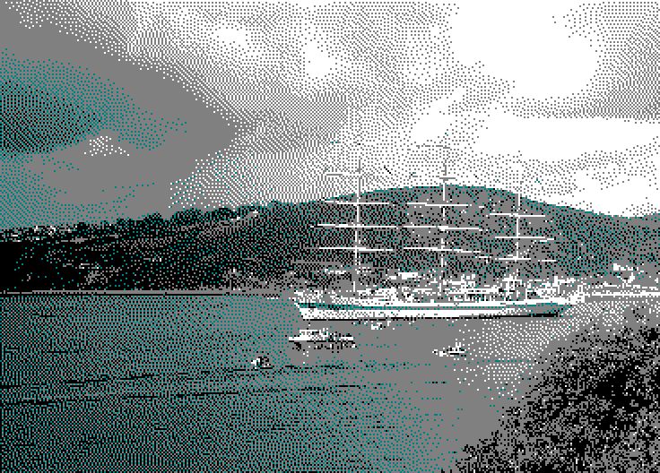 Image converted by 'CPiC'. A large, blue and white, three-masted yacht surrounded by smaller boats on calm water. In the background, green hills with trees and houses under a cloudy sky.